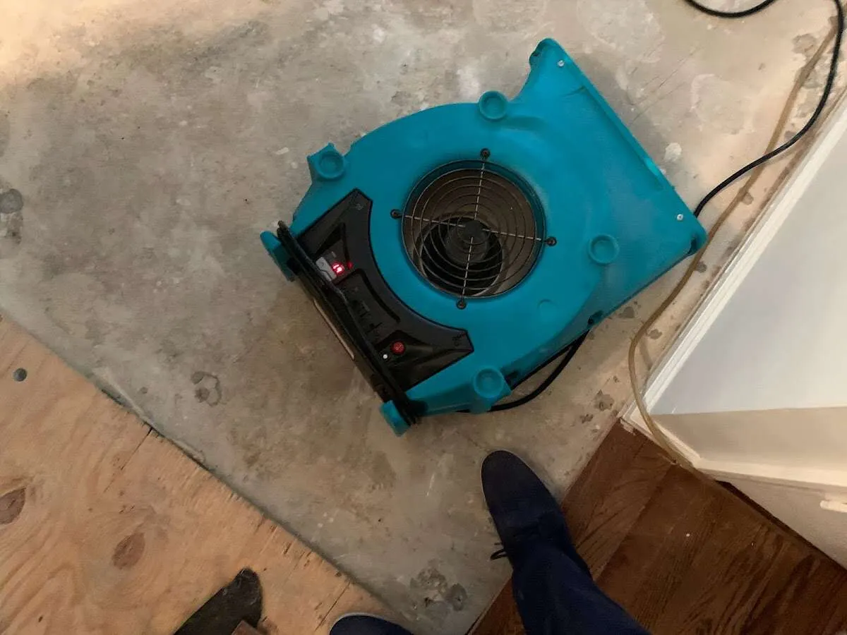 Air mover drying subfloor during Commercial Water Damage Restoration in Sanibel